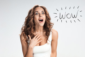 Portrait of young woman with shocked facial expression