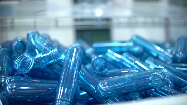 The preform of plastic bottles. Production of plastic packaging. Plant for the production of plastic containers. Machine blowing plastic bottles. A lot of blanks for plastic bottles. for packaging