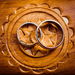 Golden rings lie over the wooden sun