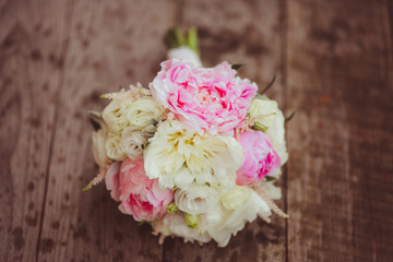 A closeup of peonies lying on the wet porch