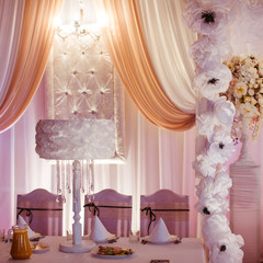 Cosy restaurant corner decorated with white cloth flowers