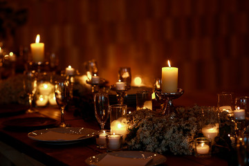 Warm light from candles illuminates a cosy room