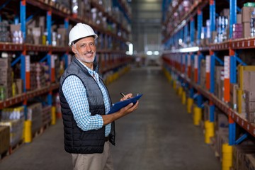 Portrait of warehouse worker checking the inventory