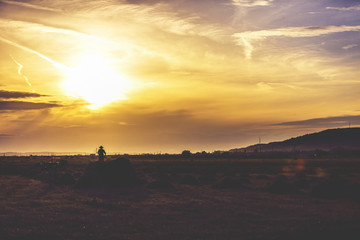 Fototapeta premium image silhouettes of farmers working in sunset