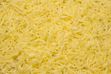 Heap of Grated pizza cheese close up texture
