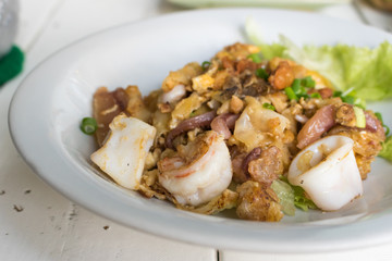 Thai food Stir fried rice noodle with chicken,squid and shrimp i