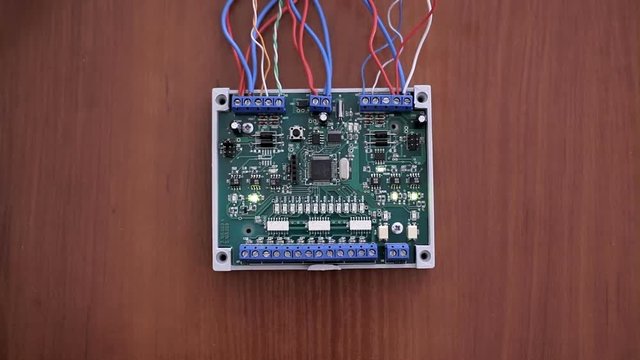 Electronic board with micro-controller and wires on a wooden table
