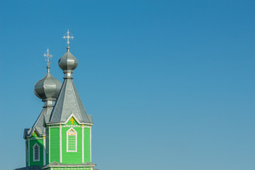 Tower with green domes against the sky