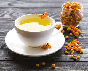 Hot tea with fresh sea buckthorn berries