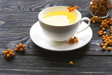 Hot tea with fresh sea buckthorn berries
