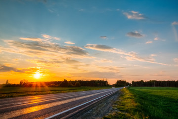 Orange sunset over the forest and the highway. Nobody