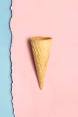 Sweet cone / Creative still life of a sweet empty wafer cone on torn wall papers background.
