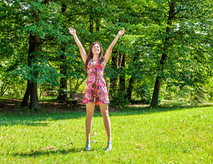 young beautiful girl standing hands up