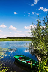 Naklejka premium A wooden boat by the river