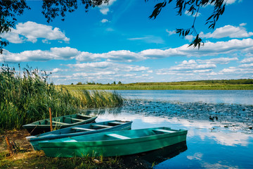 Naklejka na ściany i meble Beautiful river with wooden boats on it