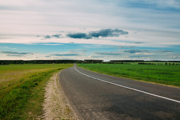 Fototapeta na wymiar Landscape with asphalt road and open fields