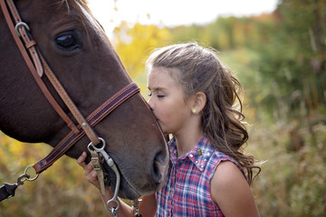 Autumn season young girl and horse
