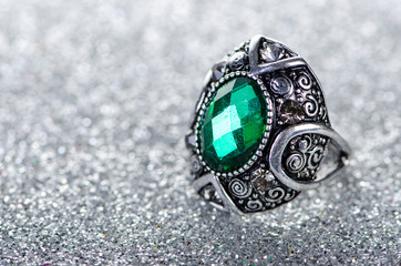 Jewellery concept with ring on shiny background