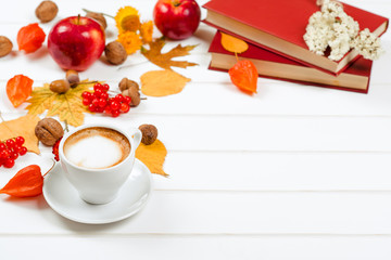 Autumn background, cup of cappuccino, books, space for text.