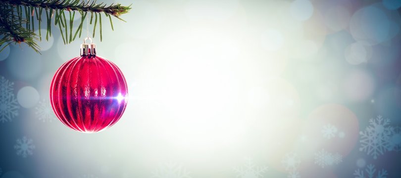 Composite image of red christmas decoration hanging from branch