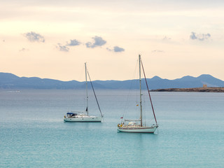 Boats archored in Cala Saona beach