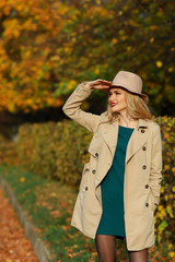 Beautiful woman looks into the distance in autumn park