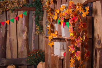 Fall leaves in wooden interior. Autumn decoration.
