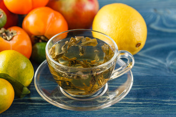 cup of green tea and lemon on rustic wooden table