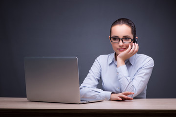 Businesswoman sitting at her desk in business concept