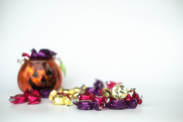 Halloween jack-o-lantern pail with spilling candy