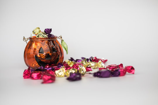Halloween jack-o-lantern pail with spilling candy