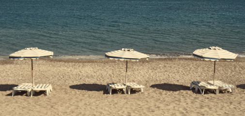 Greece. Kos island. Chairs and umbrellas on the Kefalos beach. I
