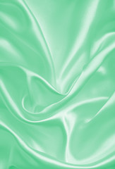 Smooth elegant green silk or satin texture as background