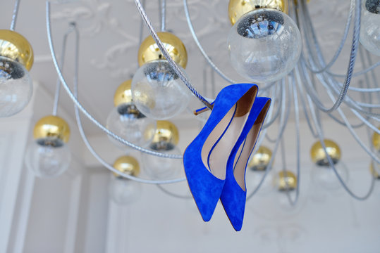 Beautiful colorful wedding shoes for bride indoors. Beauty of bridal heel for marriage. Female couple boots for celebration