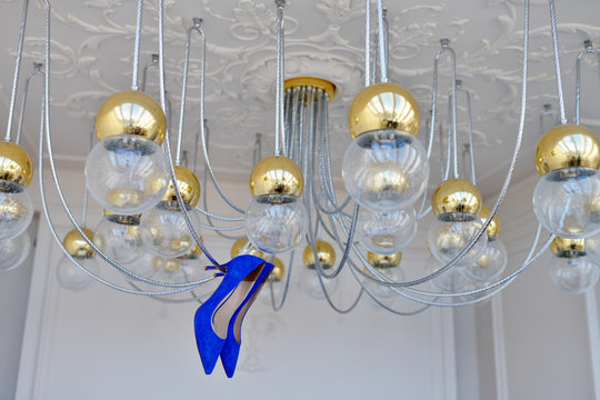 Beautiful colorful wedding shoes for bride indoors. Beauty of bridal heel for marriage. Female couple boots for celebration