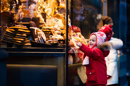 Kids looking at candy and pastry on Christmas market