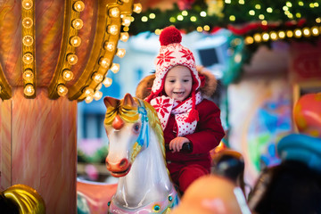 Child riding carousel on Christmas market © famveldman