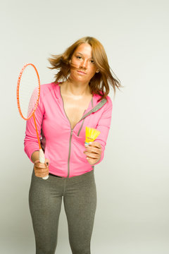 Girl playing badminton on a white background