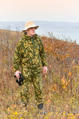 Rest of tourist/Photo - portrait of a hunter with binocular