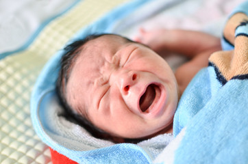 Crying cute newborn baby
