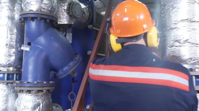 boiler heating system inspection. boiler maintenance or gas equipment at the plant. Modern pipes intertwined, and consortium, technologically. Perhaps the oil derrick. Work turns the pipe valve