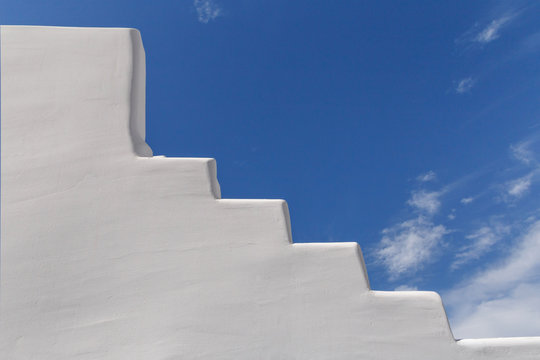 whitewashed staircase on Santorini over blue sky