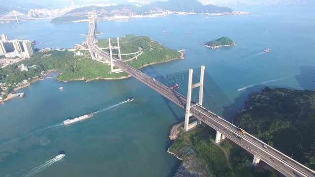 An aerial view fly over Tsing Ma Bridge under sunny day
