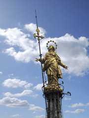 Virgin Mary gold statue on the top of Milan cathedral, Italy