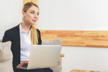 Joyful woman using computer for work