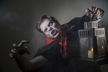 vampire count Dracula waves his hand and shows a scary gesture