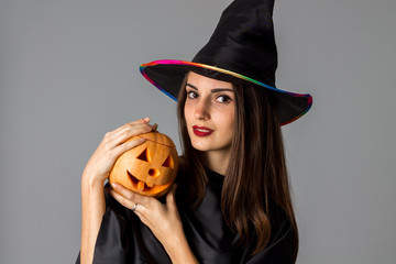 beauty brunette girl in halloween style clothes