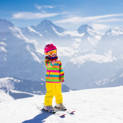Little child skiing in the mountains
