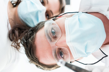 Dentist and nurse in treatment from patient point of view