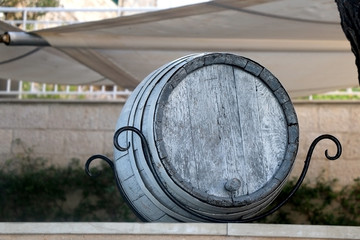 Obraz na płótnie Canvas Old wooden wine barrel displayed as a decoration. In Hvar, Croatia. Selective focus.